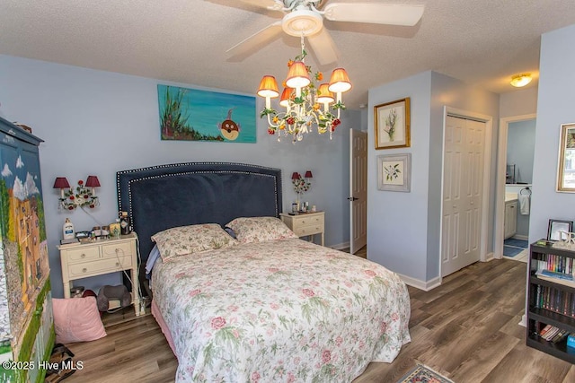 bedroom featuring a textured ceiling, a closet, baseboards, and wood finished floors