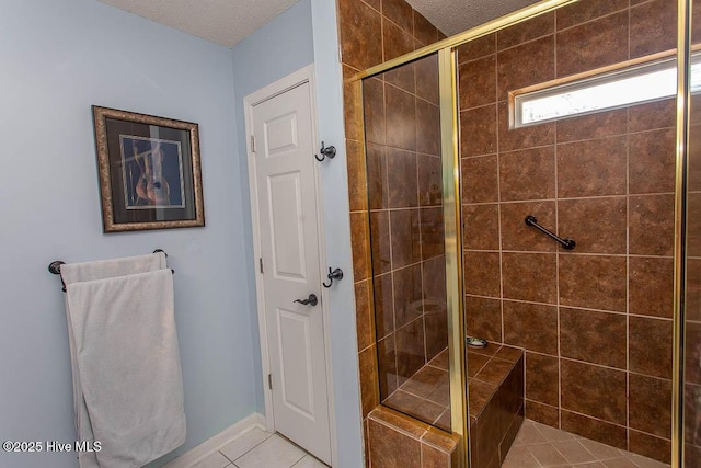 bathroom featuring a stall shower, a textured ceiling, and tile patterned floors