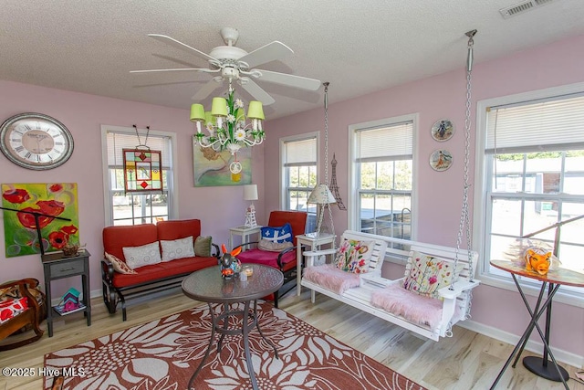 interior space with a wealth of natural light, wood finished floors, and visible vents