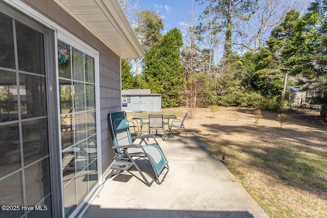 view of patio / terrace featuring an outdoor structure and a shed