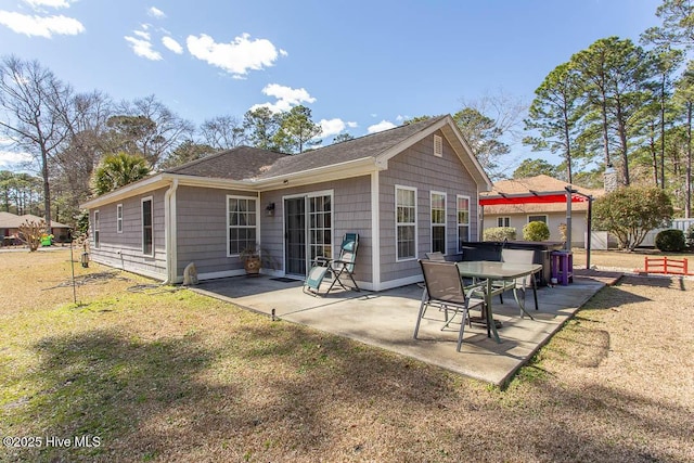 back of house with a lawn and a patio area