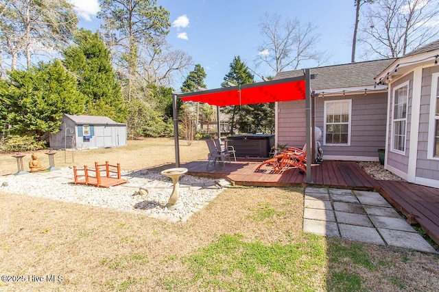 view of yard with an outdoor structure, a hot tub, a wooden deck, and a shed