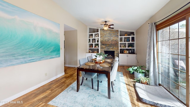 office featuring a ceiling fan, wood finished floors, built in features, and baseboards