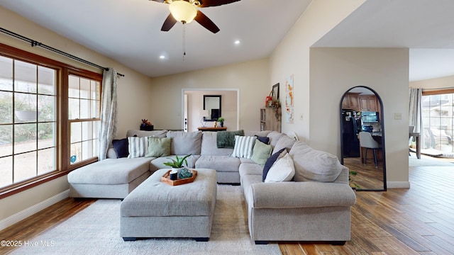 living room with ceiling fan, recessed lighting, wood finished floors, baseboards, and vaulted ceiling