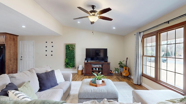 living area featuring light wood finished floors, baseboards, ceiling fan, vaulted ceiling, and recessed lighting