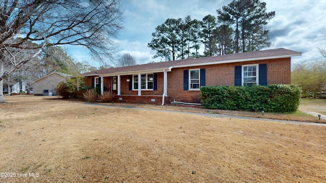 ranch-style house with a front yard, crawl space, and brick siding