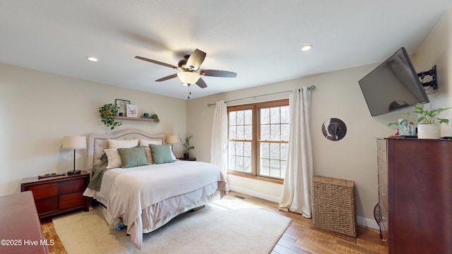 bedroom with a ceiling fan, recessed lighting, light wood-style flooring, and baseboards