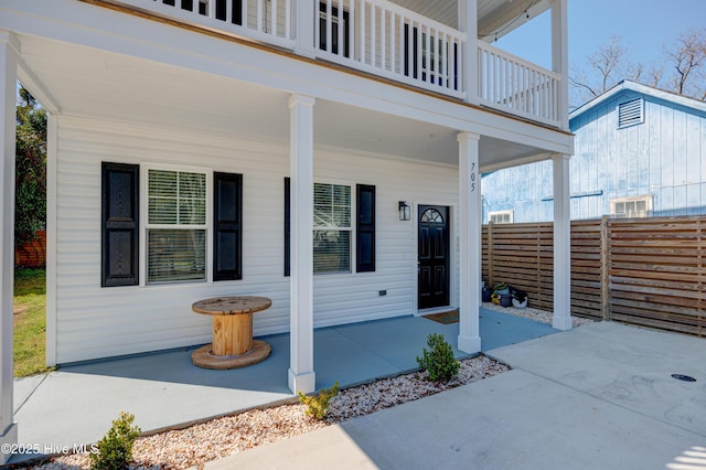 property entrance featuring a patio and fence