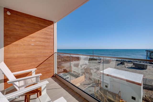 balcony with a view of the beach and a water view