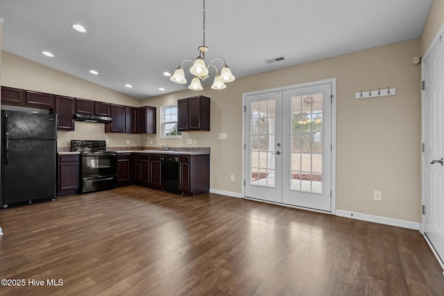 kitchen with dark brown cabinets, visible vents, black appliances, and dark wood-style flooring