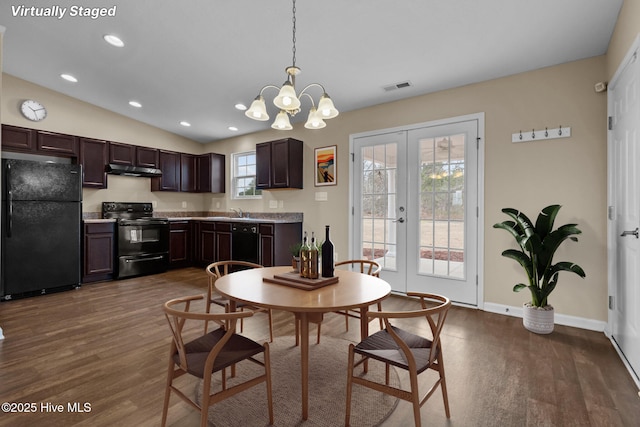 dining space with lofted ceiling, dark wood-style floors, visible vents, and french doors