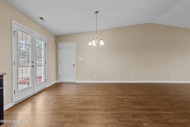 interior space featuring wood finished floors, visible vents, an inviting chandelier, vaulted ceiling, and french doors