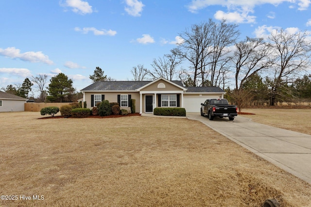 ranch-style home featuring a front lawn, fence, a garage, and driveway