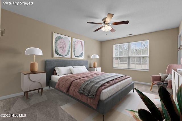 carpeted bedroom featuring visible vents, a ceiling fan, and baseboards