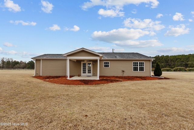 rear view of property with french doors, a yard, and a patio area