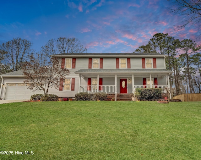 view of front of house featuring a porch, a front yard, driveway, and a garage