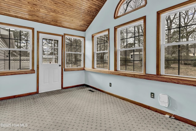 unfurnished sunroom with vaulted ceiling, wooden ceiling, visible vents, and a healthy amount of sunlight