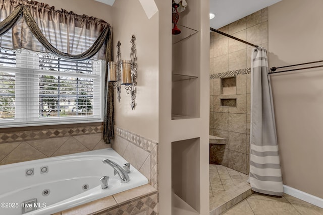 bathroom with baseboards, a tile shower, a tub with jets, and tile patterned floors