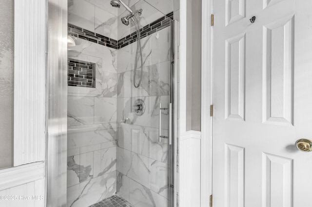 bathroom with a marble finish shower