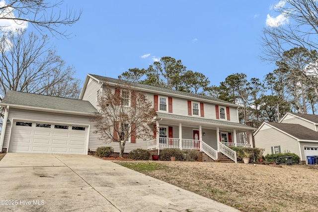 colonial-style house with an attached garage, driveway, and a porch