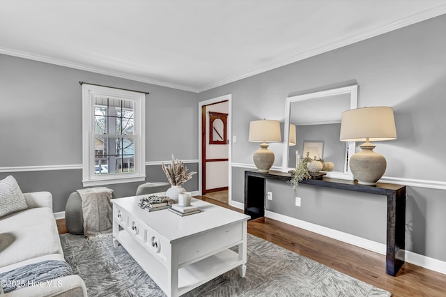 living area with crown molding, baseboards, and wood finished floors