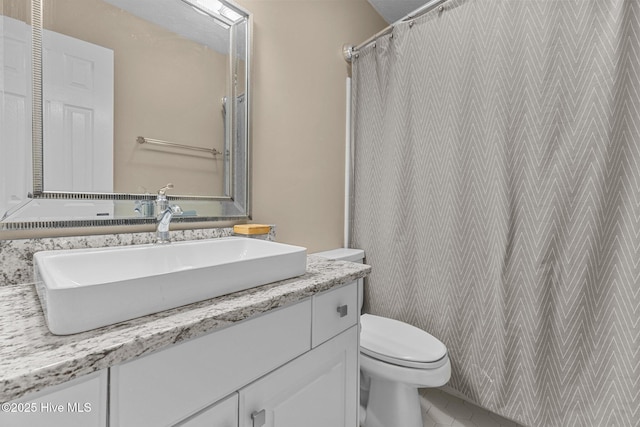 bathroom featuring toilet and vanity