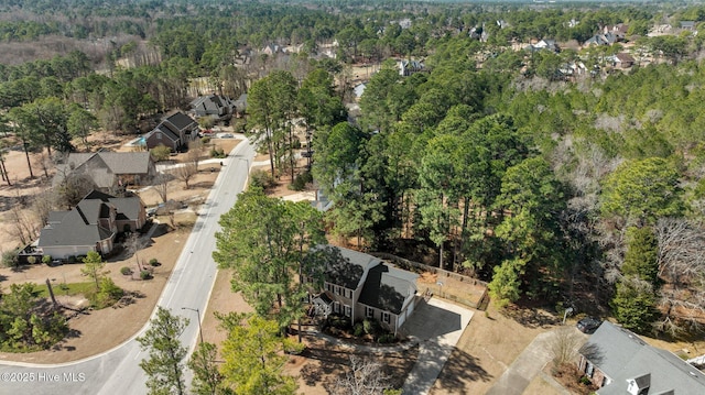 bird's eye view featuring a residential view and a wooded view