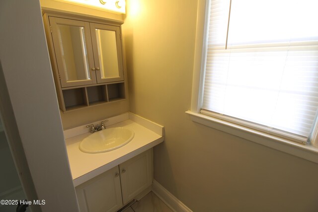 bathroom featuring vanity and baseboards