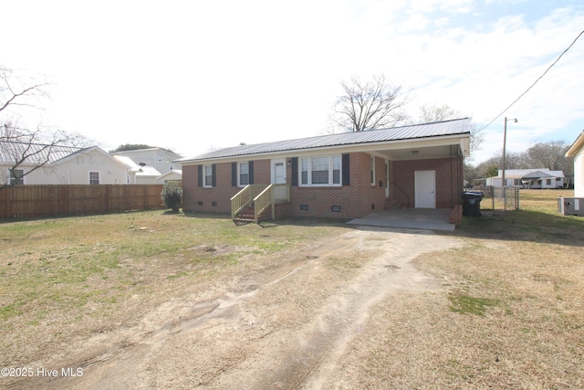 ranch-style house featuring an attached carport, crawl space, brick siding, and dirt driveway