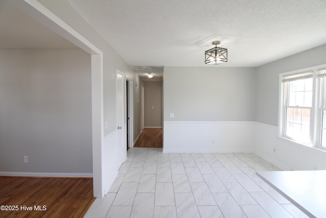 spare room with a textured ceiling