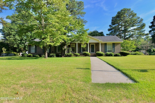 view of front facade with brick siding and a front yard