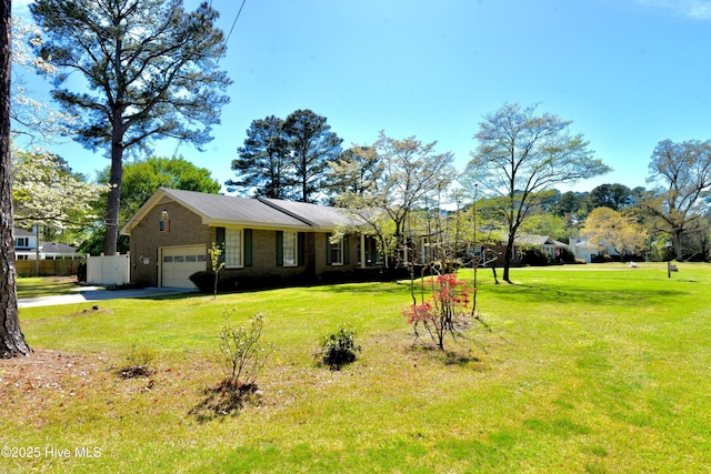 view of front of house with driveway, fence, and a front lawn