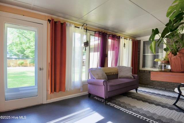 sitting room with finished concrete flooring and baseboards