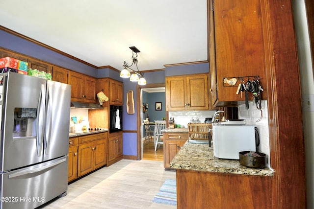 kitchen featuring stainless steel fridge, ornamental molding, and brown cabinetry