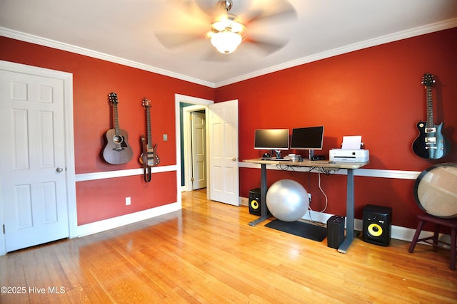 office area featuring baseboards, a ceiling fan, light wood-style flooring, and crown molding