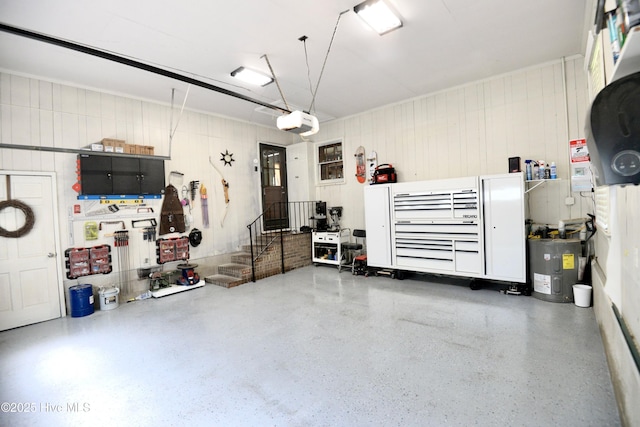 garage with a workshop area, electric water heater, and a garage door opener