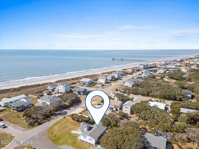 birds eye view of property with a water view and a view of the beach