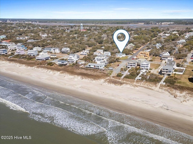 drone / aerial view with a water view and a beach view