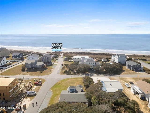 birds eye view of property featuring a water view, a view of the beach, and a residential view