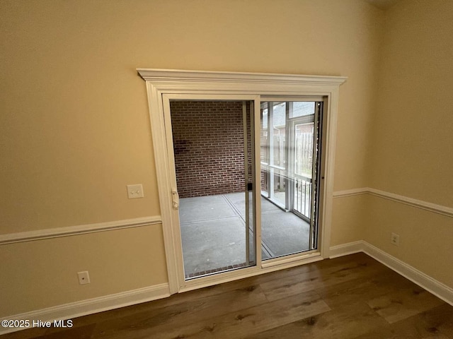 entryway with dark wood-style floors and baseboards