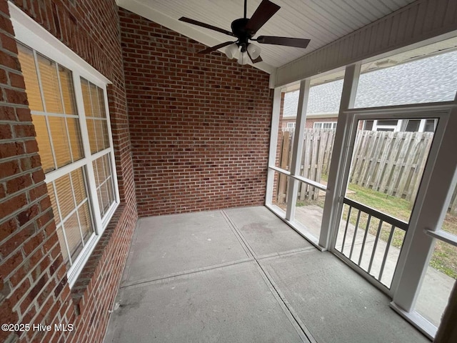 unfurnished sunroom featuring lofted ceiling