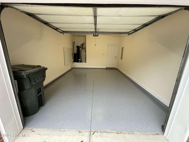 garage featuring electric panel, water heater, and baseboards