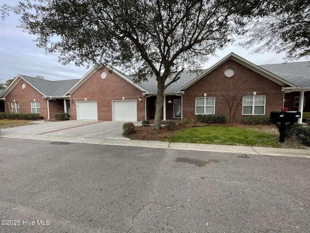 ranch-style home featuring concrete driveway, brick siding, a front lawn, and an attached garage