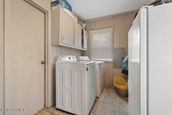 clothes washing area with cabinet space and washer and dryer