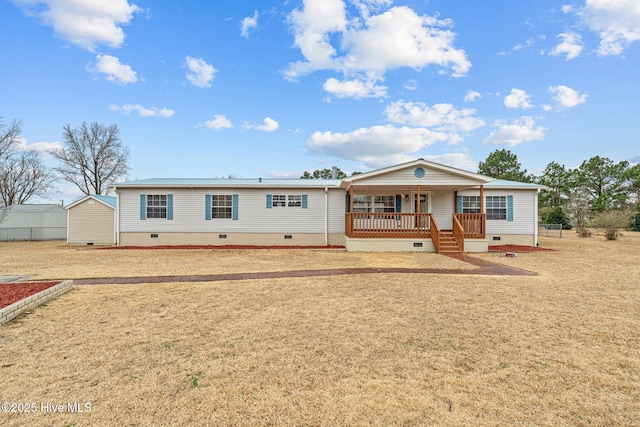 manufactured / mobile home with a porch, crawl space, and a front lawn