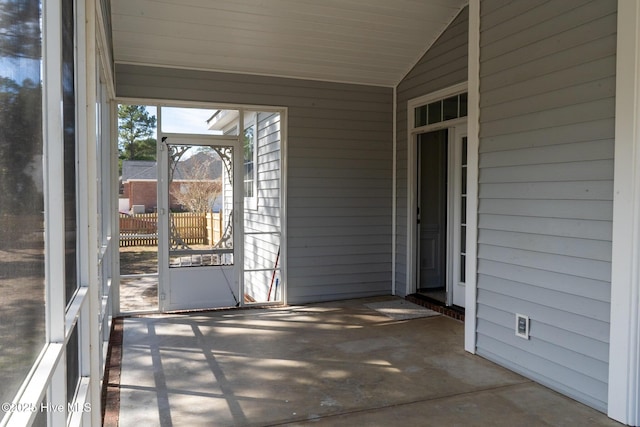 unfurnished sunroom with vaulted ceiling