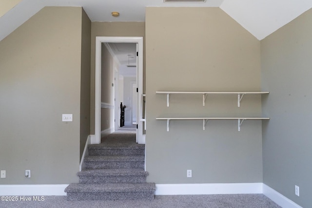 stairs featuring attic access, visible vents, baseboards, carpet, and vaulted ceiling