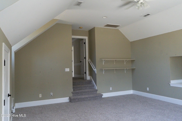 additional living space featuring lofted ceiling, visible vents, and carpet