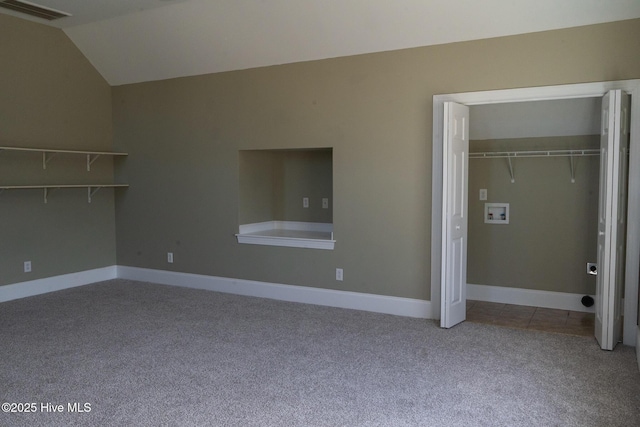 unfurnished bedroom featuring carpet floors, a closet, visible vents, vaulted ceiling, and baseboards