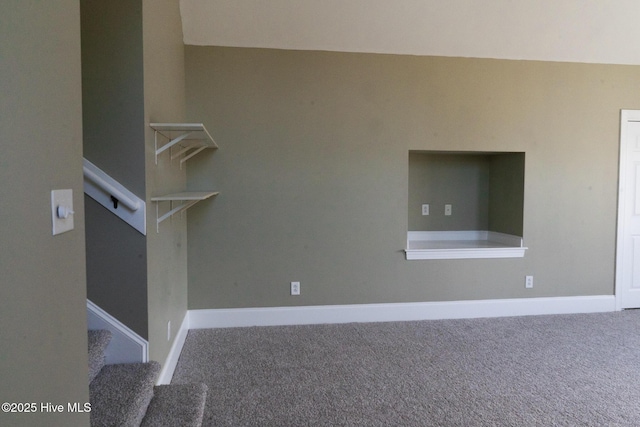 unfurnished room with carpet floors, stairs, and baseboards